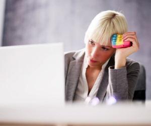 Frustrated woman staring at her laptop, trying to understand recent policy changes