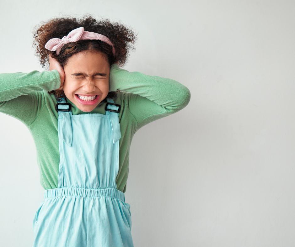 Anxious girl covering her ears.