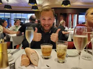 Man smiling and celebrating after booking a successful vacation with a travel agent
