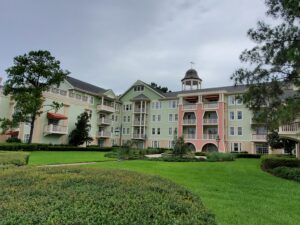 Photo of Saratoga Springs Resort with green landscaping in front. 