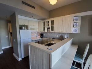 Overview of a white kitchen in a Disney Beach Resort Villa. 